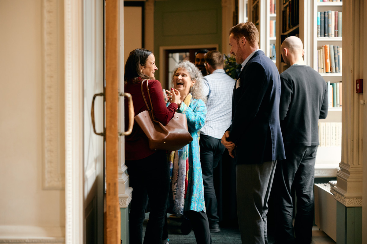 Guests in conversation in a doorway at The Emergence, Royal Institution
